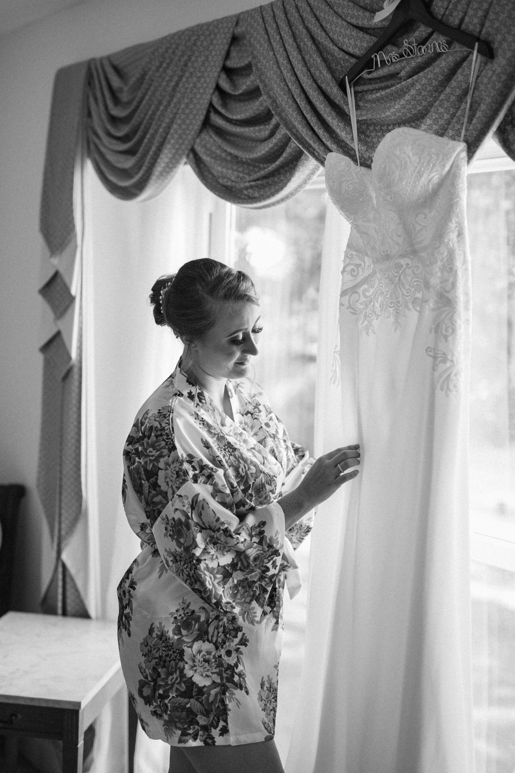 Timeless bride in Charleston, South Carolina admiring her wedding dress.
