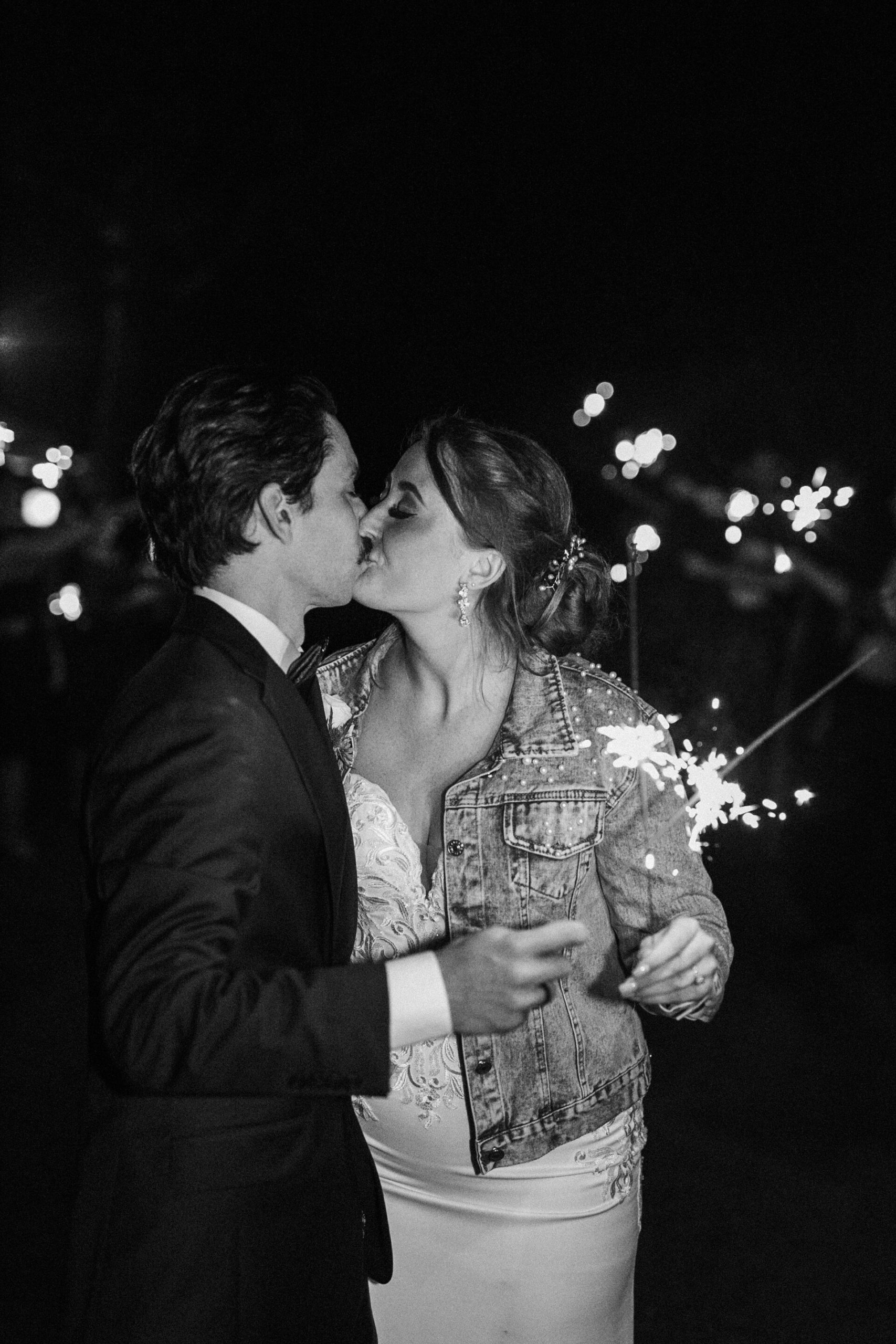 Charleston couple kisses as they have a sparkler exit from their wedding.