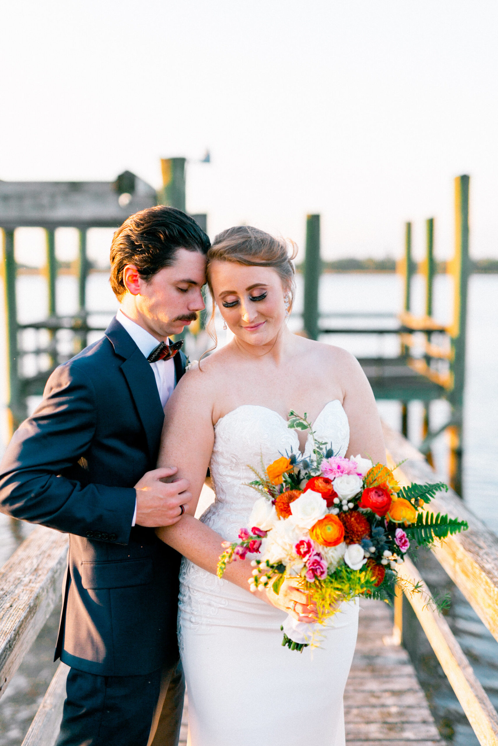 Charleston couple at sunset by the waterfront after their wedding.