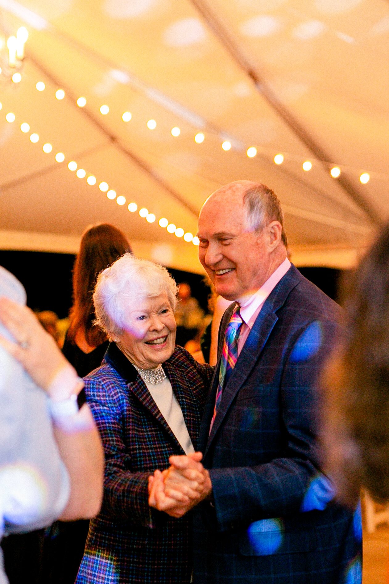 Joyful grandparents share a dance together at a Charleston wedding.