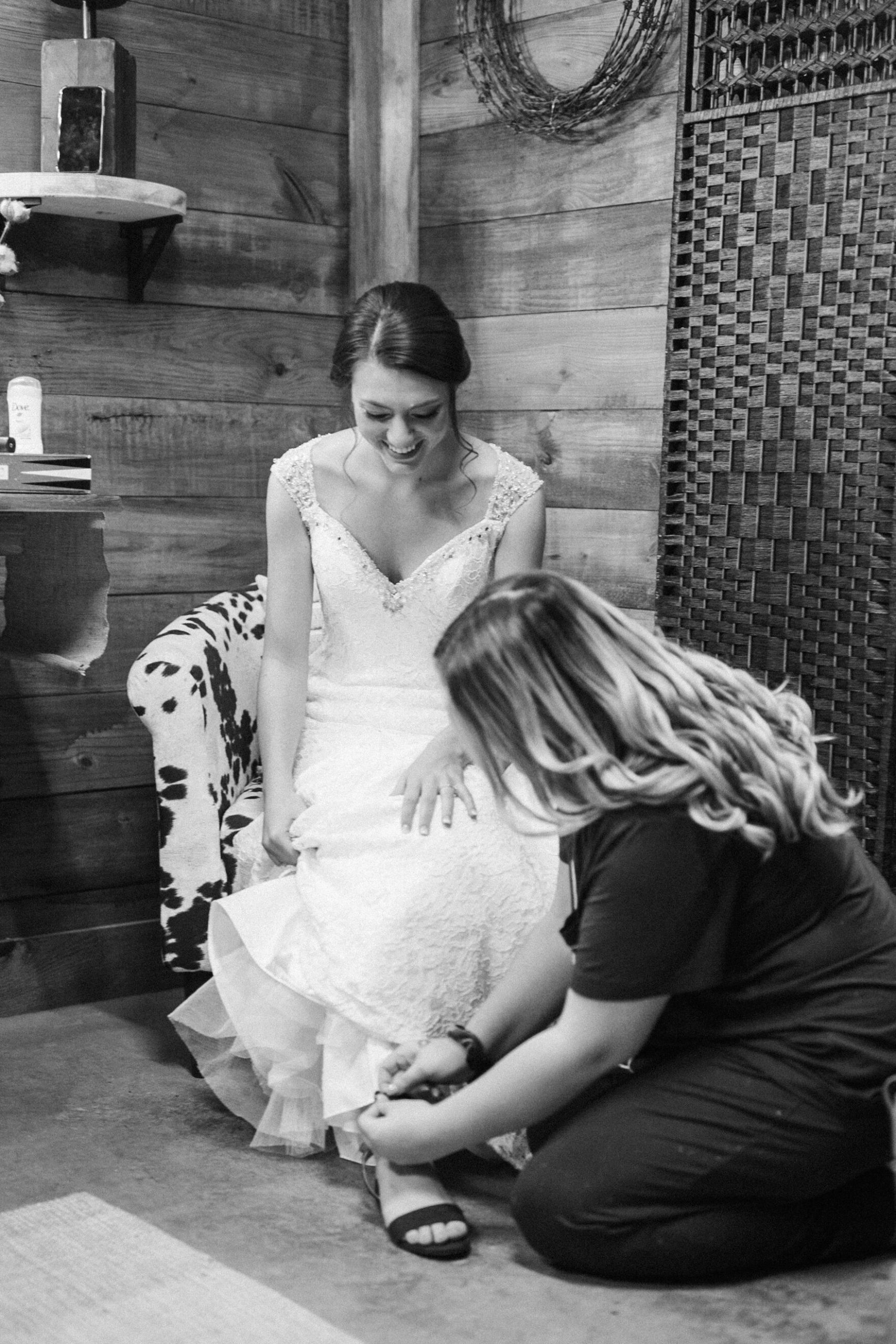 Maid of honor helps the bride get ready for her Christmas wedding.