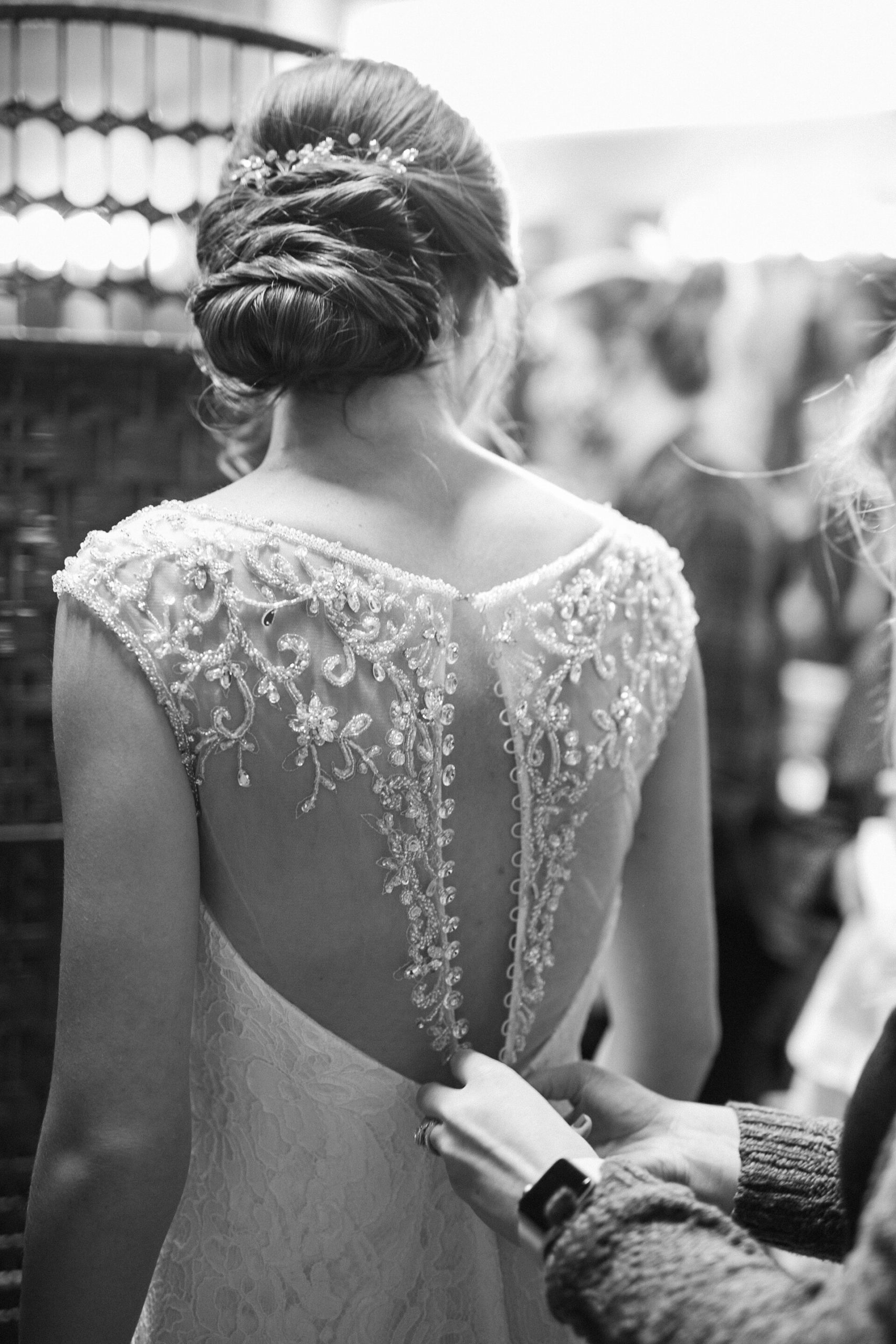 Bride puts on her lace beaded wedding dress at Charleston plantation wedding.