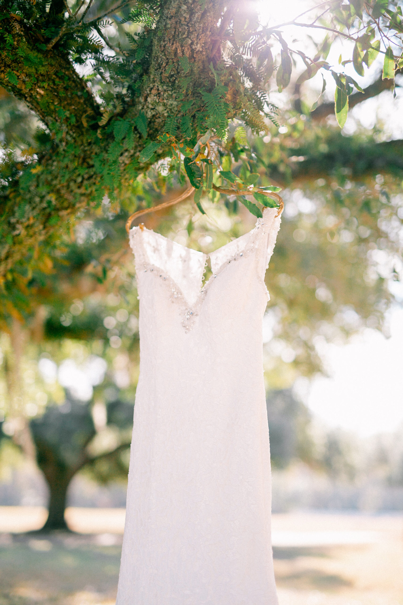Close up portrait of beaded white wedding dress.