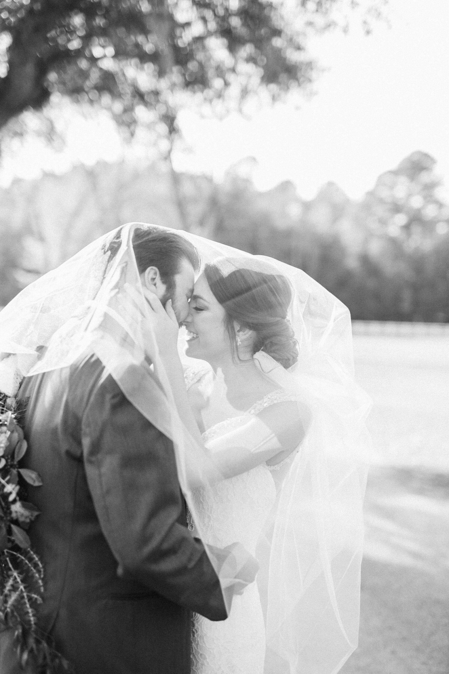 Intimate veil shot of the classy bride and groom in Charleston.