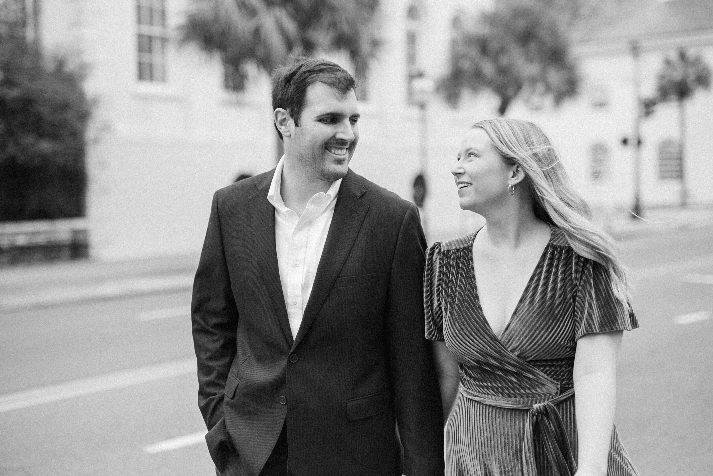 Stunning Charleston couple walk during their joyful engagement portrait session in South Carolina.
