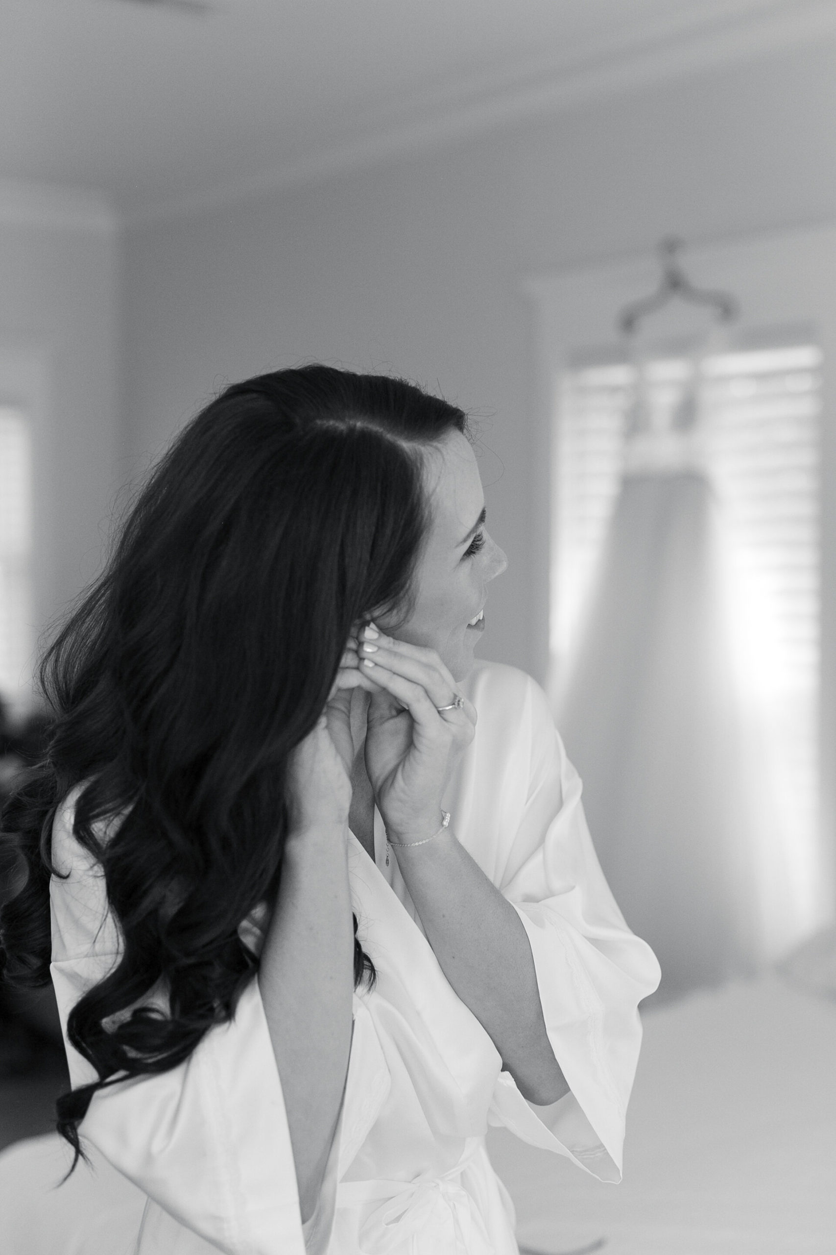 bride puts on the finishing touches to her look for her wedding day