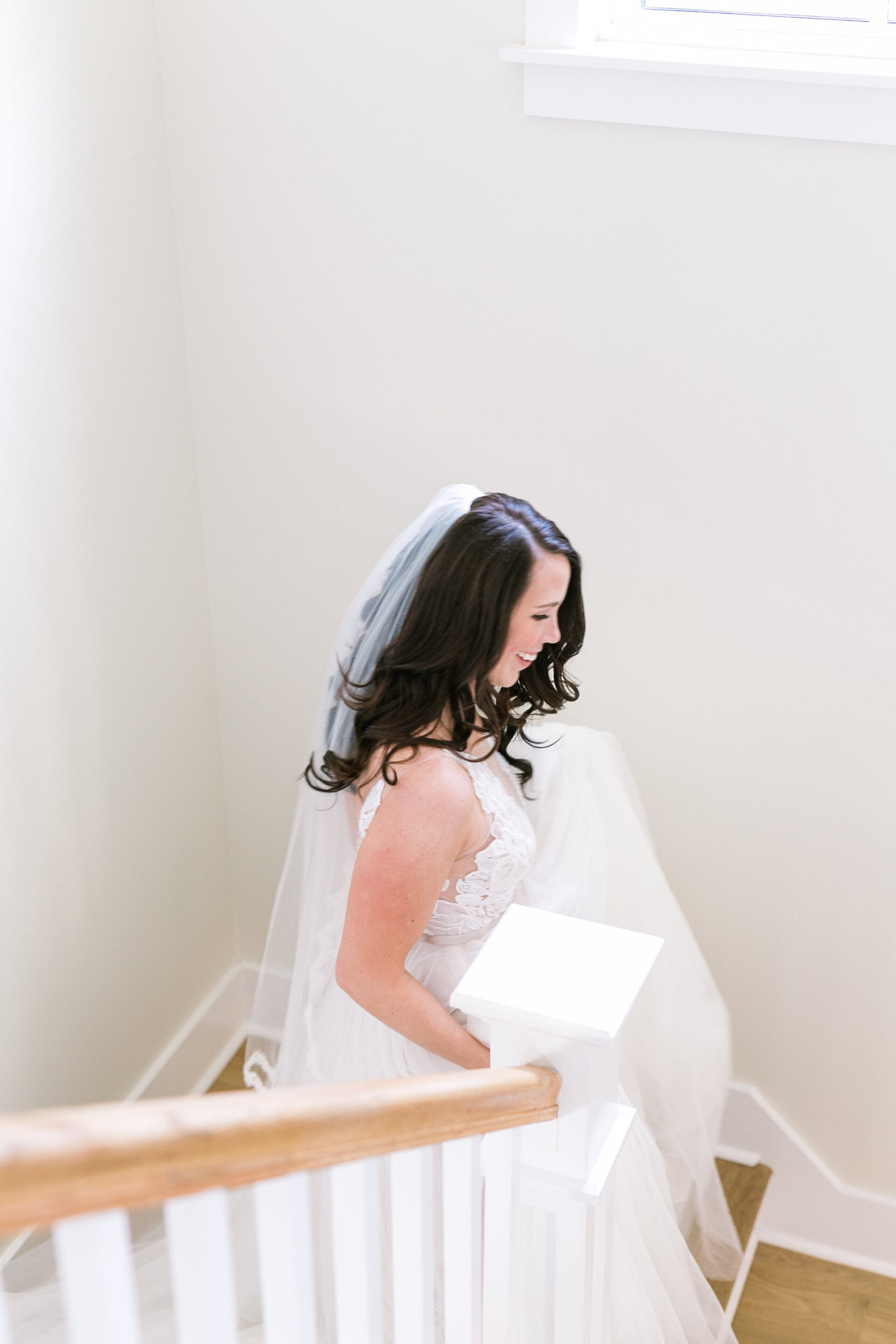 bride walks down the stairs for her first look in Charleston wedding