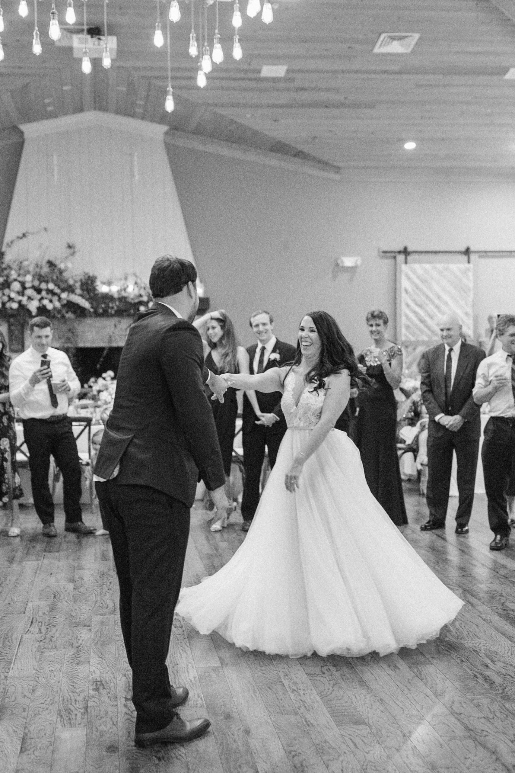 Bride spins on the dance floor during first dance at Charleston, South Carolina southern wedding