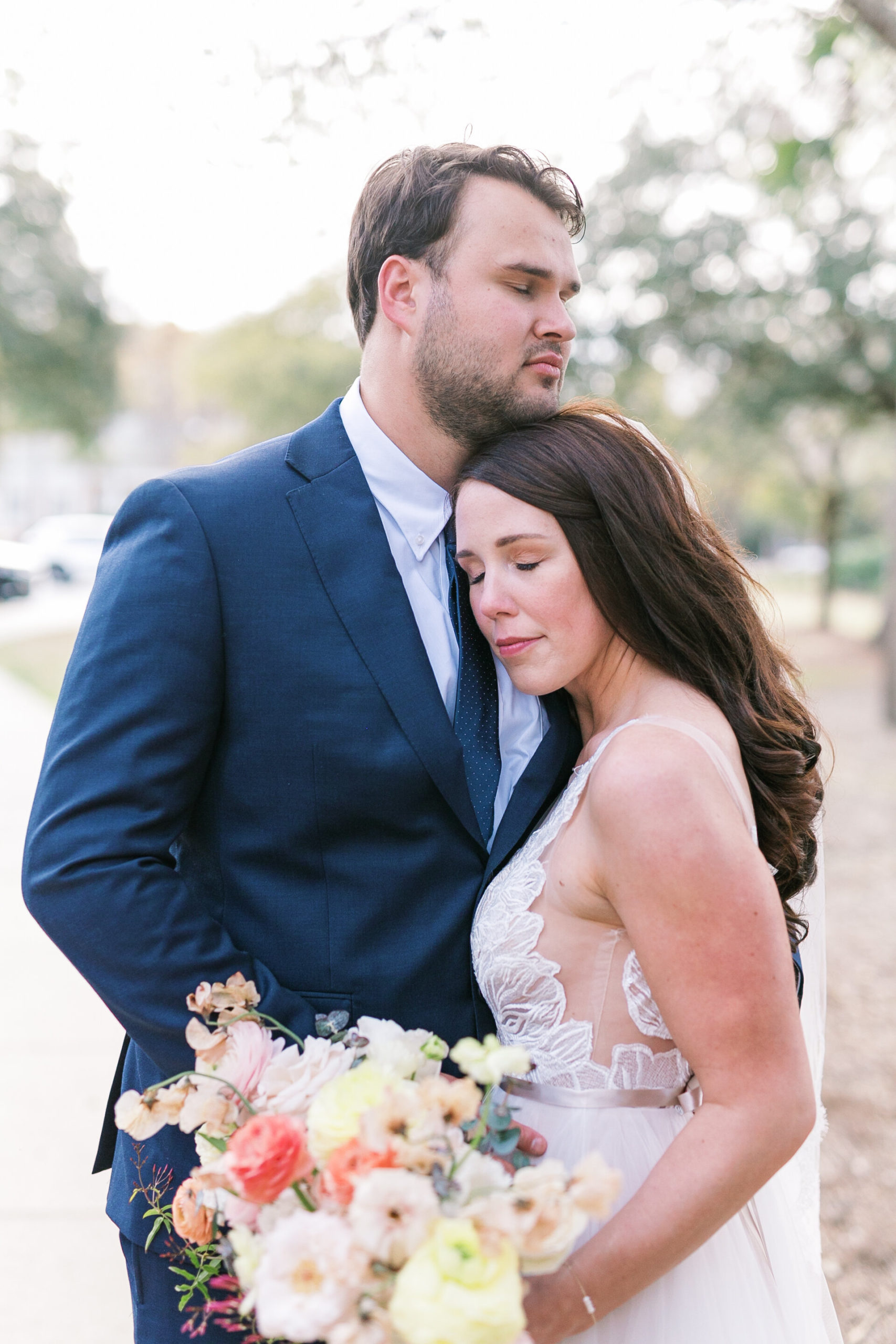 Bride and groom snuggle for portraits as husband and wife in Charleston, South Carolina