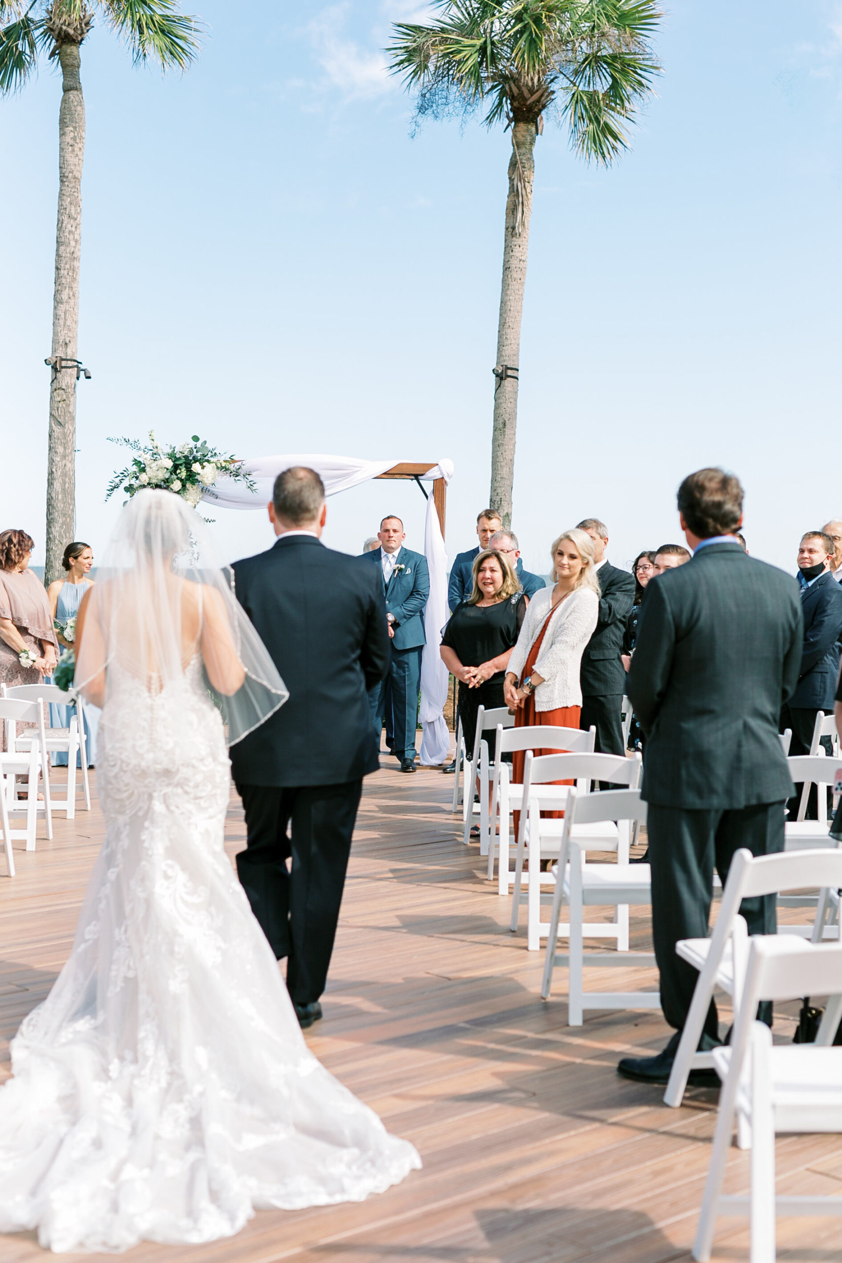 Hilton Head wedding photographer gets shot of bride walking down the aisle at seaside wedding ceremony