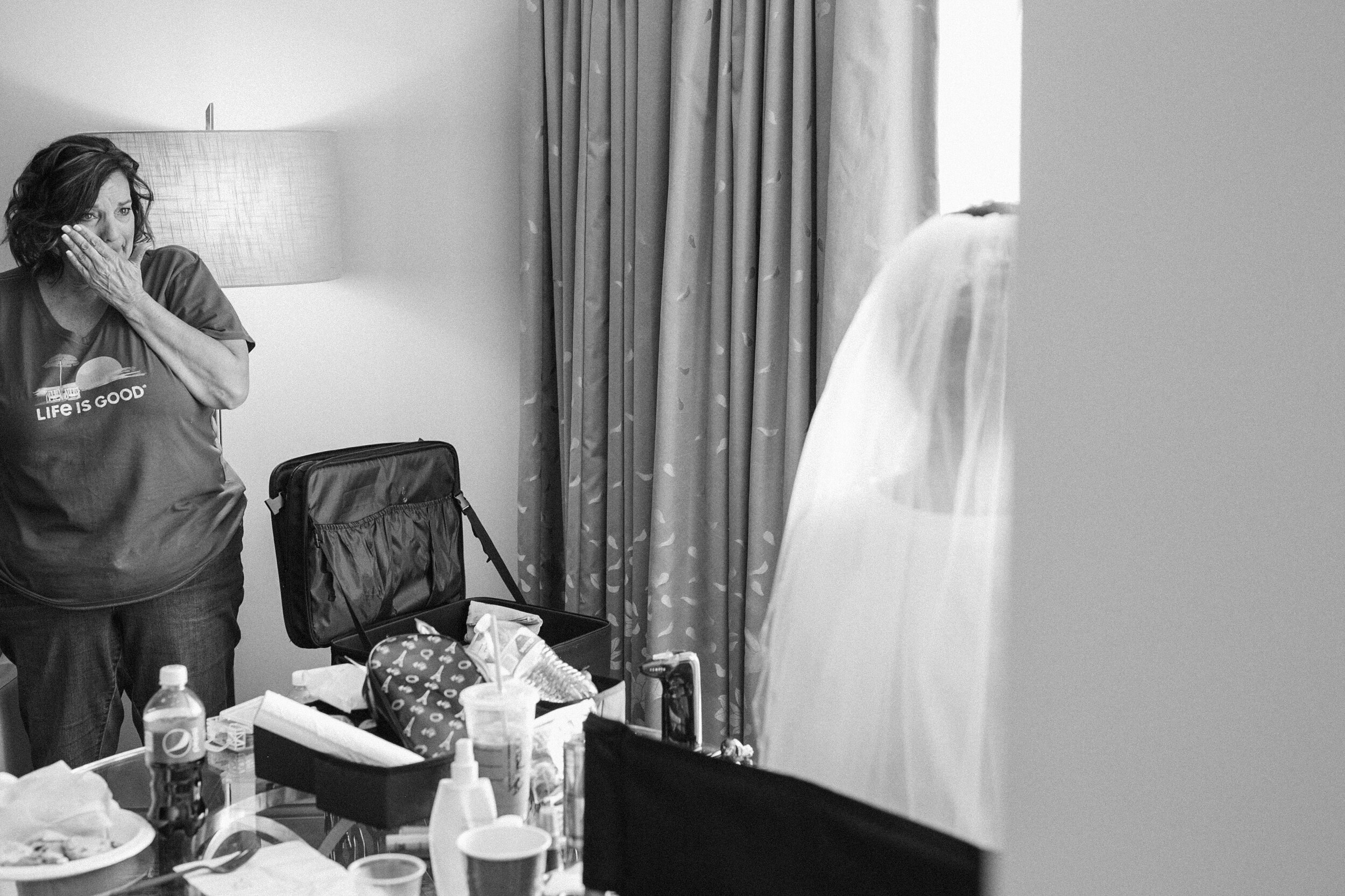 Tearful mother of the bride watches the bride getting ready at her South Carolina wedding day.