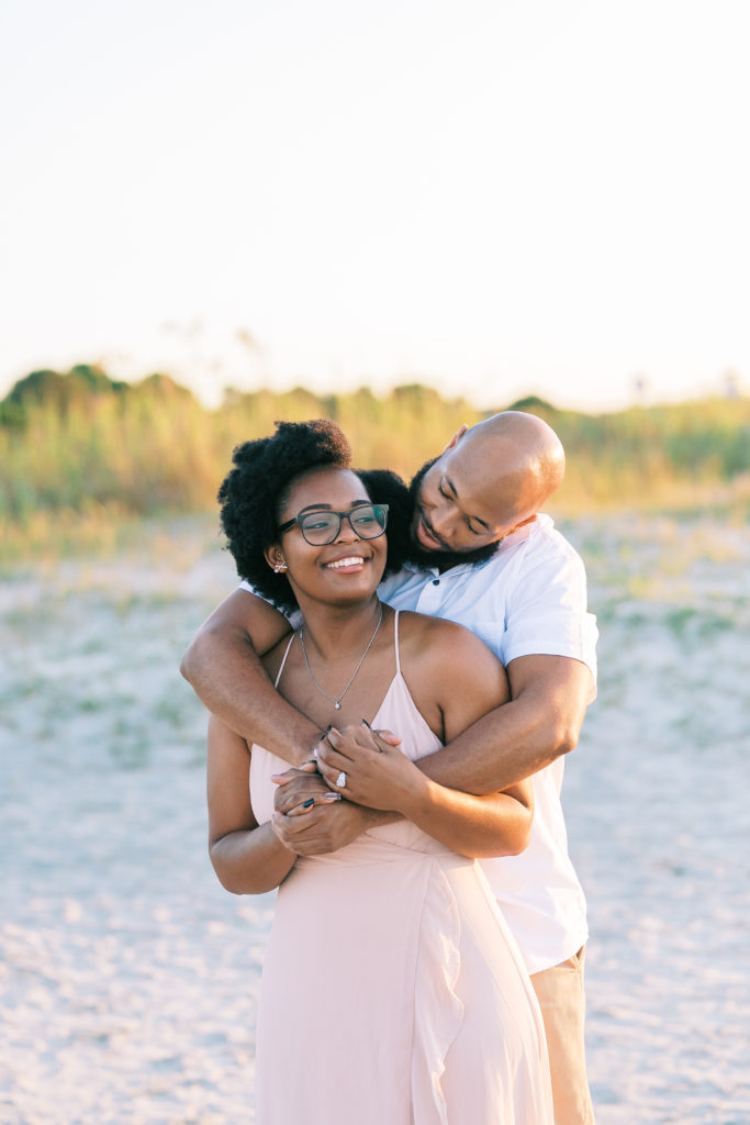 Candid couple enjoys engagement photos at Charleston beach
