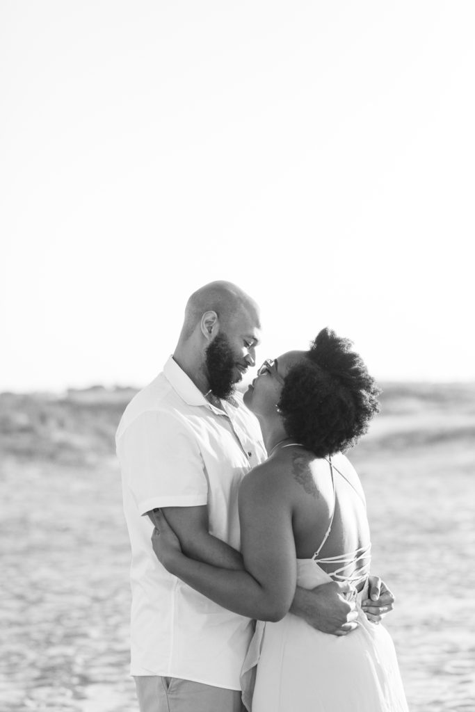 Candid couple shares sweet embrace in engagement photos Charleston