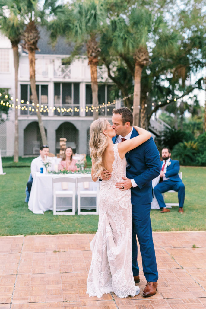 Couple shares a kiss during first dance at elegant Charleston wedding inspiration