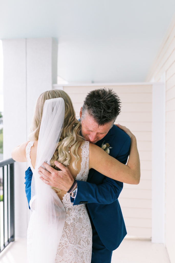 Father and bride share hug on her wedding day in Charleston, South Carolina