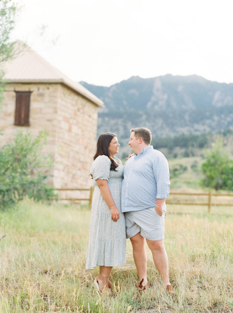 Attractive Denver couple in Boulder engagement photos with mountains in the background