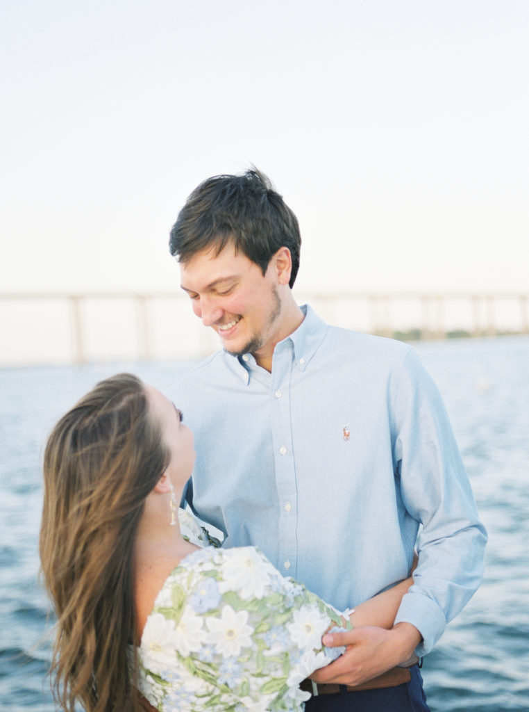 Groom gazes lovingly at bride-to-be in Charleston Harbour engagement photos