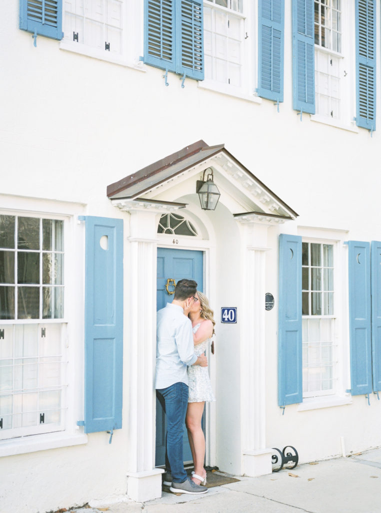 Engaged couple shares a kiss on Tradd Street in Charleston