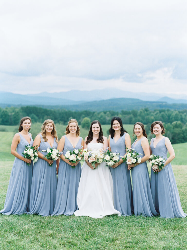 Bridesmaids portraits at Chattooga Belle Farms Wedding with blue dresses and mountains backdrop