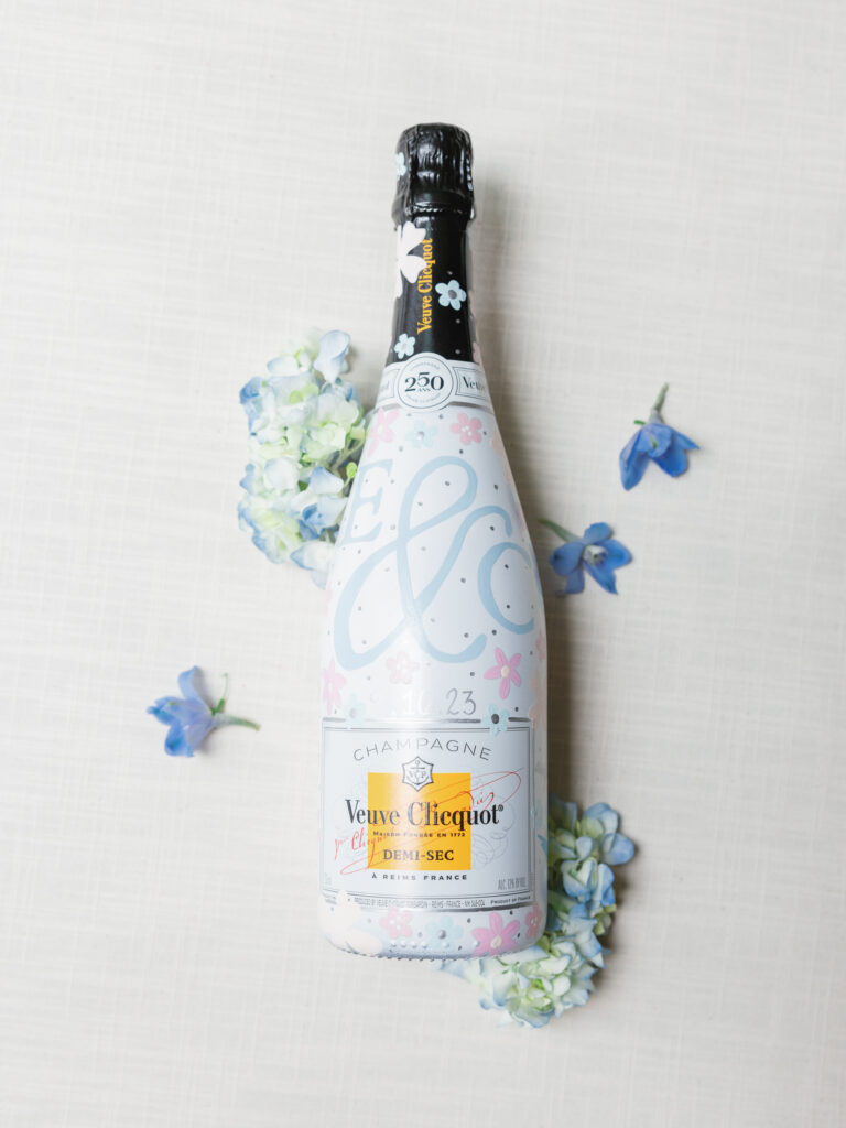 Custom wedding crest painted onto champagne bottle