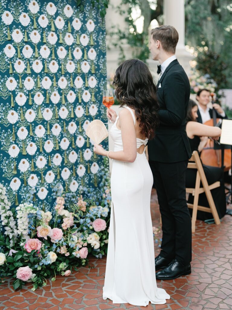 Escort card display wall inspiration with wallpaper at Charleston wedding reception