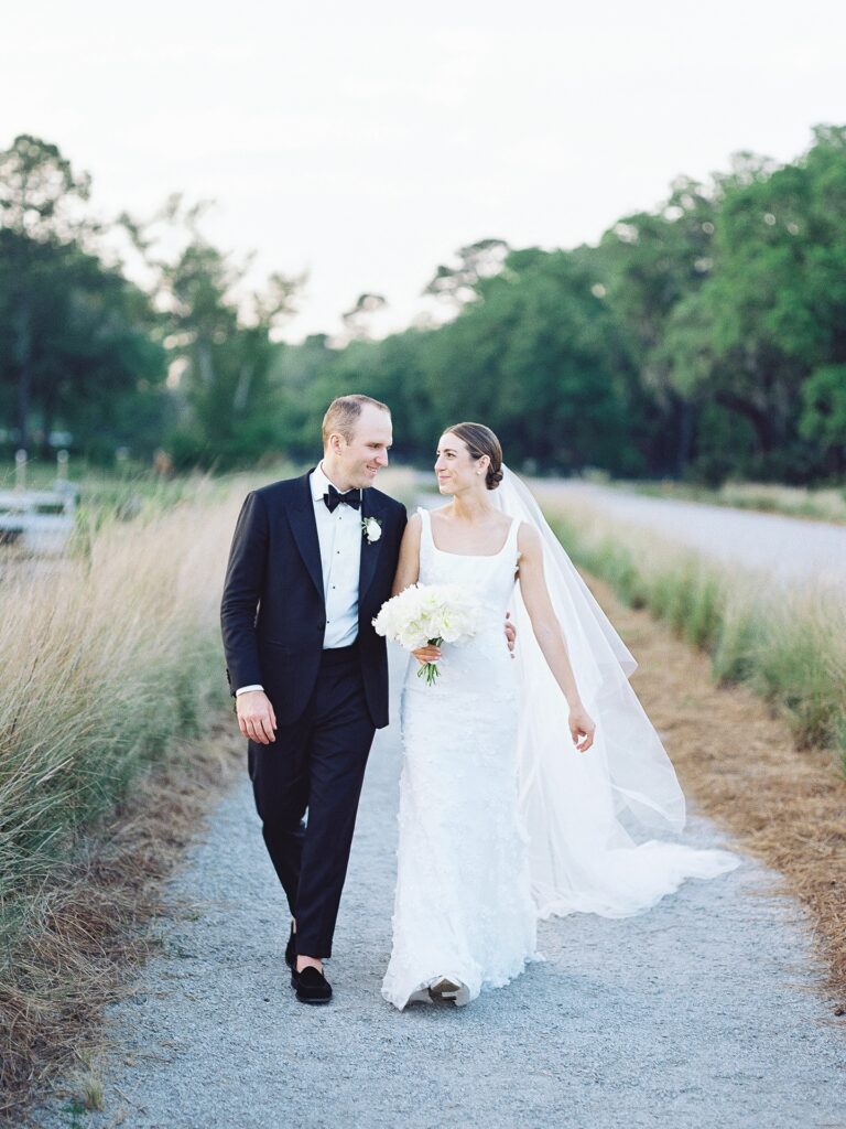 Bride and Groom walk together at the Dunlin Kiawah River