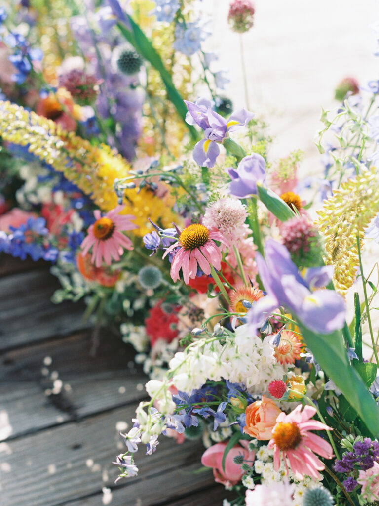 Whimsical outdoor wedding ceremony surrounded by seasonal blooms at Boulder Flower Farm.