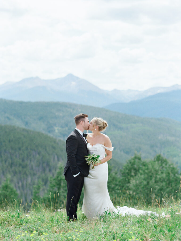 Couple shares kiss at mountain wedding venue in Boulder CO