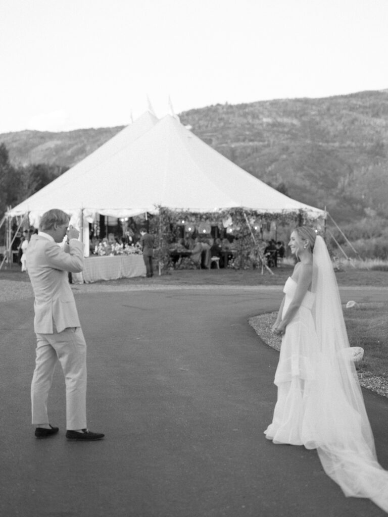Couple takes a picture of one another outside a sailcloth tent in Boulder Colorado