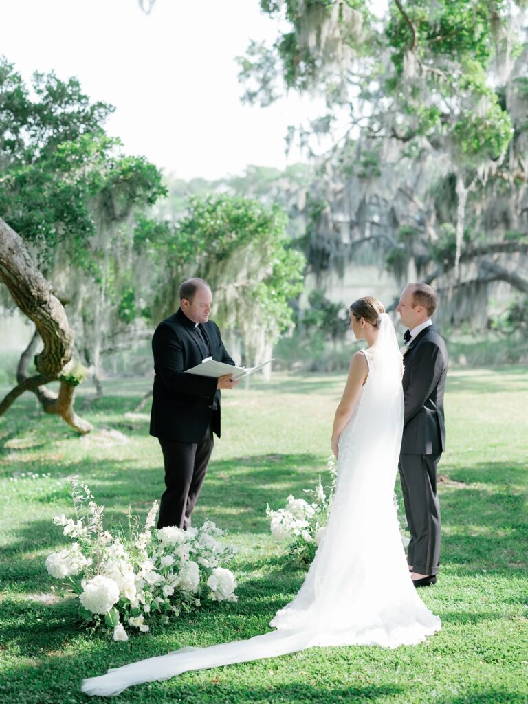 Outdoor wedding ceremony under the oak trees at The Dunlin Kiawah River