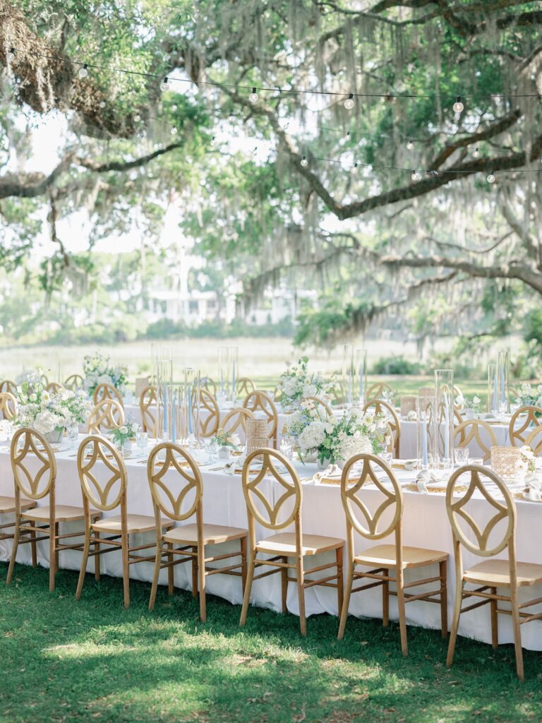 Al fresco wedding reception under oak trees at The Dunlin Kiawah River