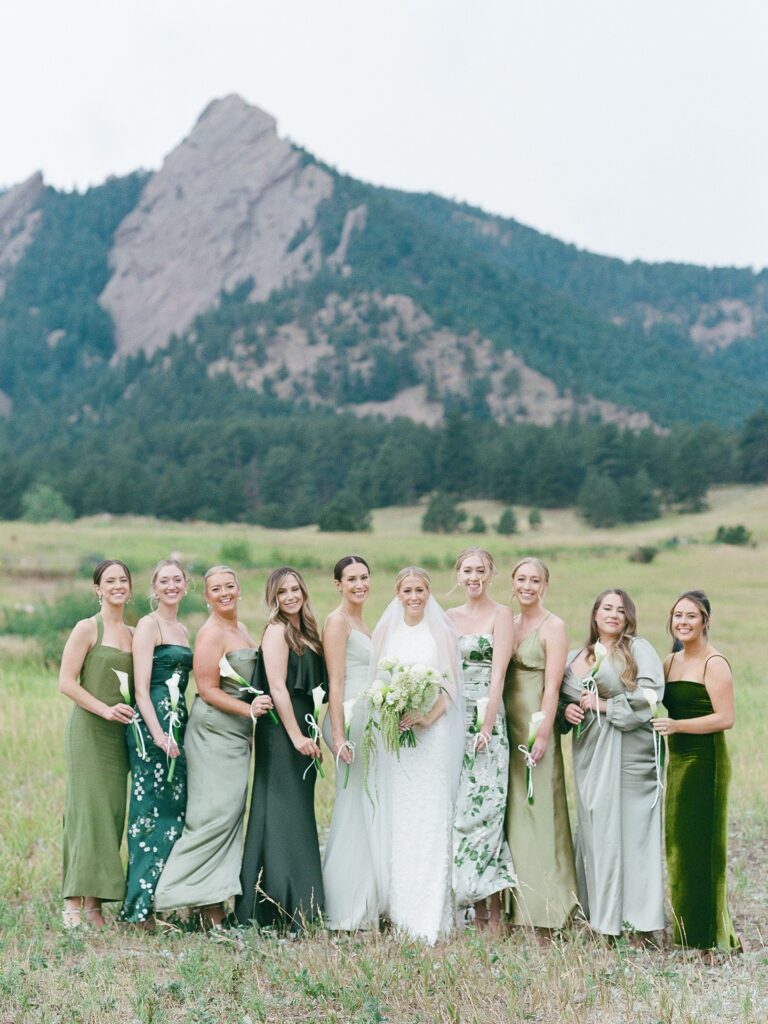 Bridesmaids in green dresses at a St Julien Boulder wedding with mountain modern garden party style