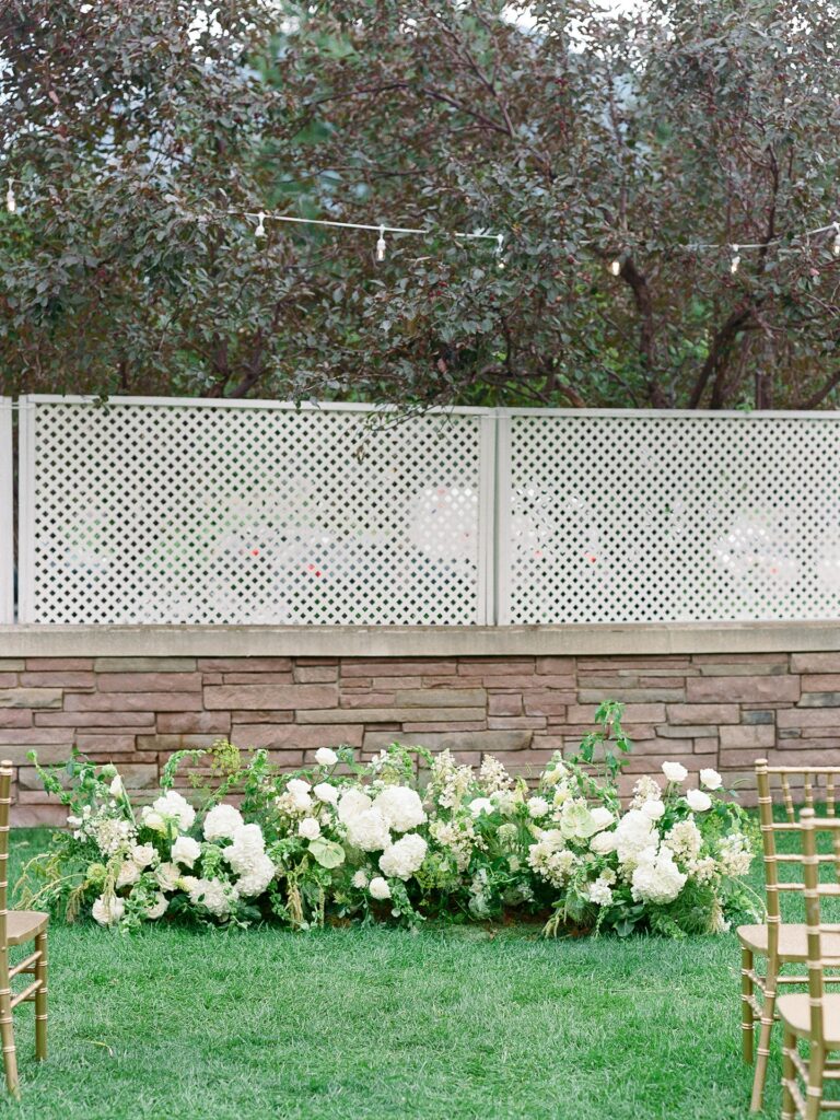 Half circle floral ceremony design at a St Julien Boulder wedding with organic green and white arrangements